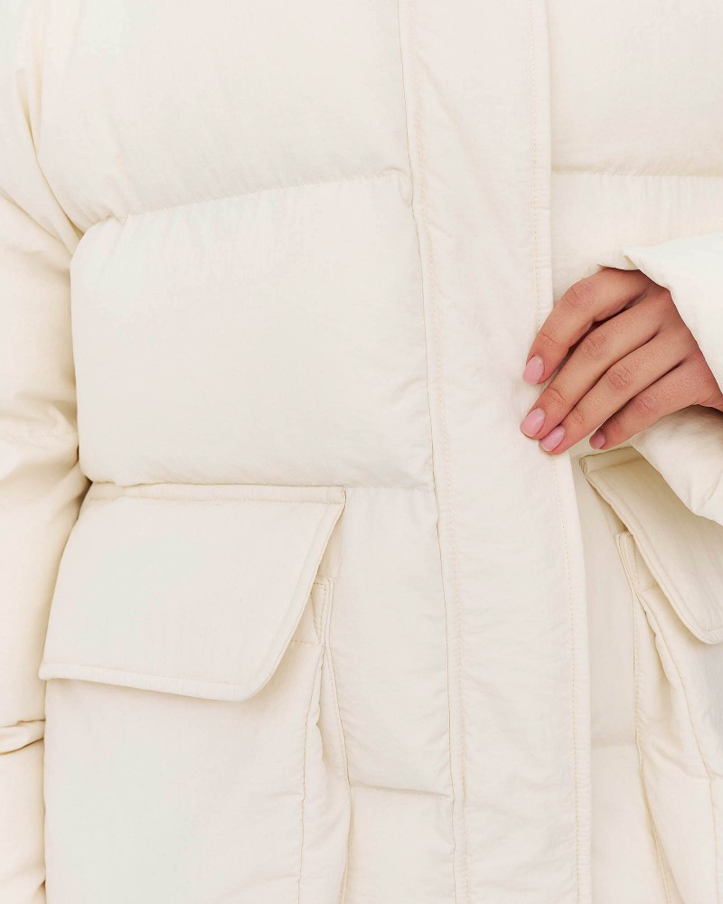 Молочна стьобана куртка з накладними кишенями
FASHIONISTA